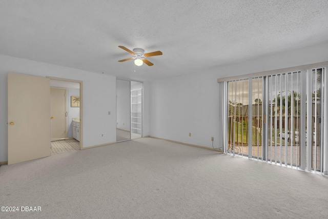 interior space with a closet, access to outside, a textured ceiling, light colored carpet, and ceiling fan