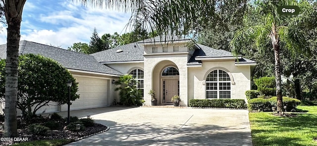 view of front of property featuring a garage and a front lawn