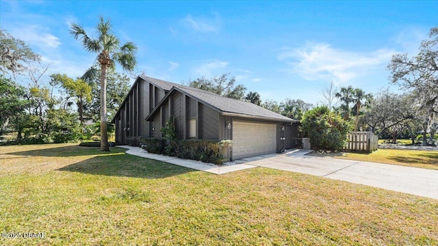 view of side of property with a garage and a yard