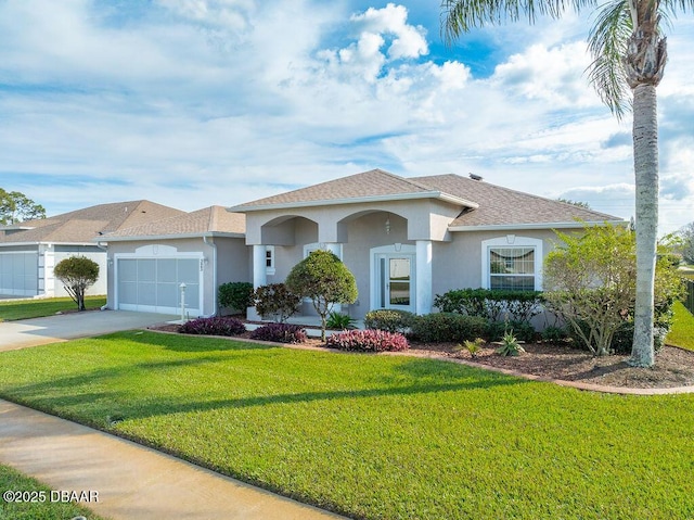 view of front of property with a garage and a front yard