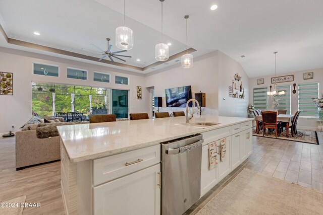 6232 W Fallsgrove Ln, Port Orange, FL 32128 - kitchen featuring stainless steel dishwasher, hanging light fixtures, white cabinets, and a kitchen island with sink