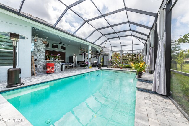 6232 W Fallsgrove Ln, Port Orange, FL 32128 - view of swimming pool featuring an outdoor bar, a patio, glass enclosure, and ceiling fan