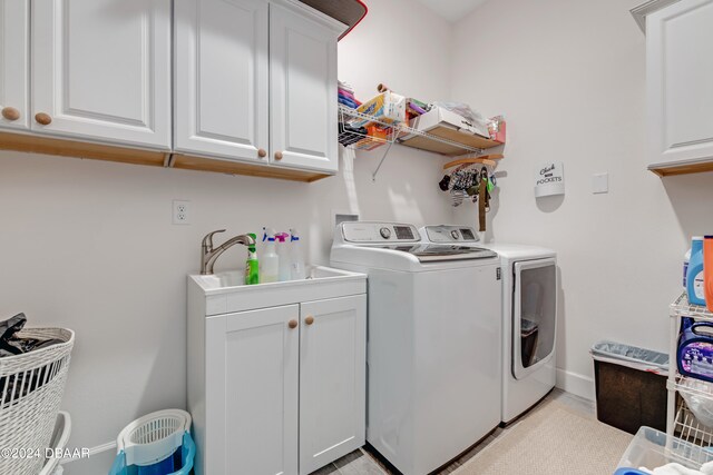 6232 W Fallsgrove Ln, Port Orange, FL 32128 - laundry area with cabinets, washing machine and dryer, and sink