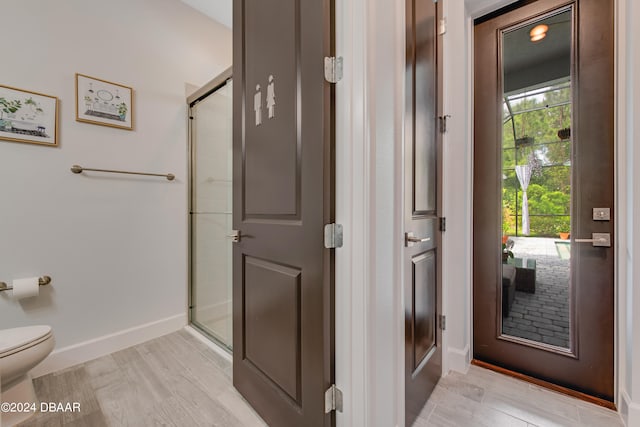 6232 W Fallsgrove Ln, Port Orange, FL 32128 - bathroom with hardwood / wood-style floors, a shower with shower door, and a healthy amount of sunlight