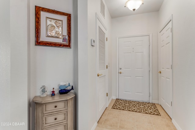 doorway with light tile patterned flooring