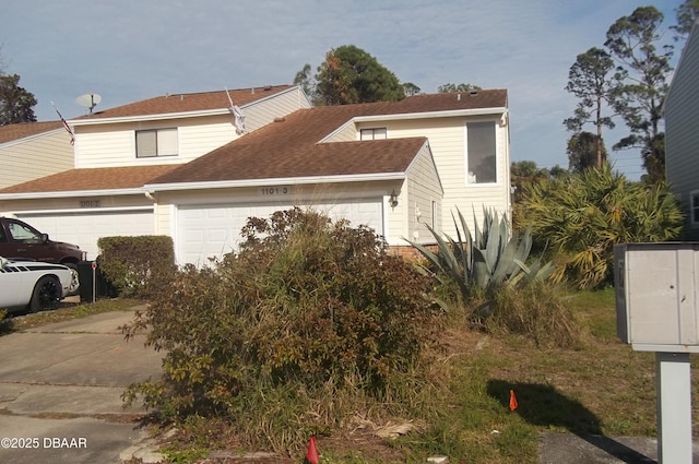 view of property exterior featuring driveway, a shingled roof, and a garage