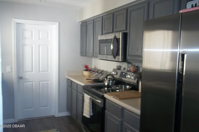 1101 Monticello Ln Unit 3, Port Orange, FL 32129 - kitchen with stainless steel appliances, dark wood-type flooring, light countertops, and gray cabinetry