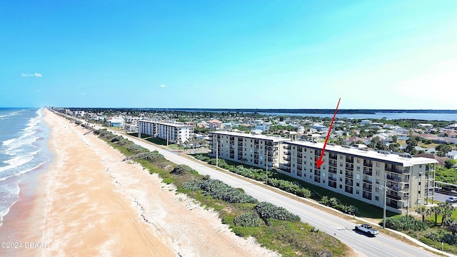 bird's eye view with a water view and a beach view