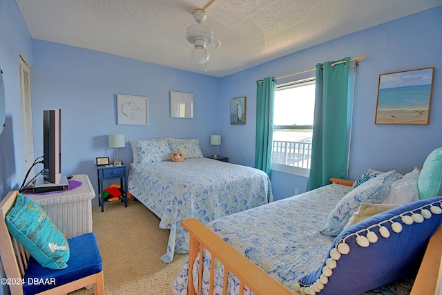 bedroom with a textured ceiling, light carpet, and ceiling fan