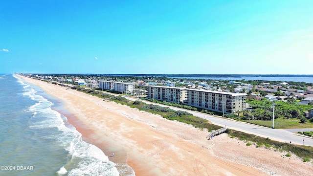 birds eye view of property with a beach view and a water view