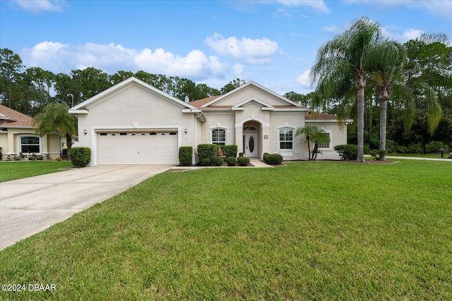 view of front facade with a front yard and a garage