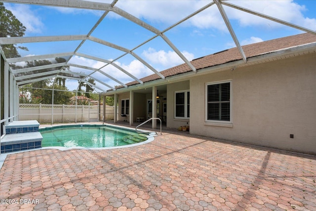 view of pool featuring ceiling fan, a patio area, and a lanai