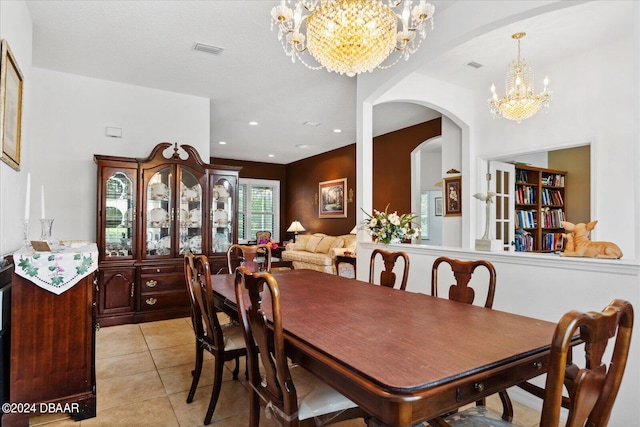 tiled dining room featuring an inviting chandelier