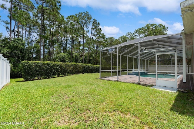 view of yard with a lanai and a fenced in pool