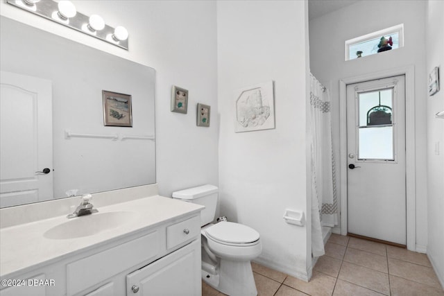 bathroom with toilet, vanity, tile patterned floors, and a shower with shower curtain