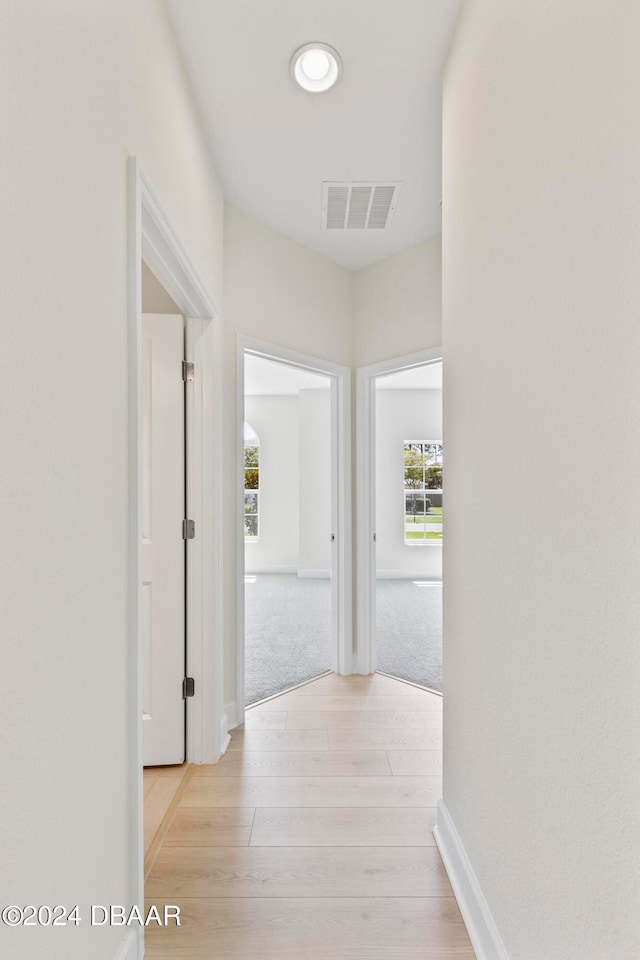 hall with light hardwood / wood-style floors