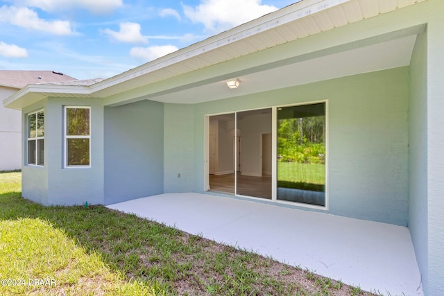 exterior space with a patio area and a yard