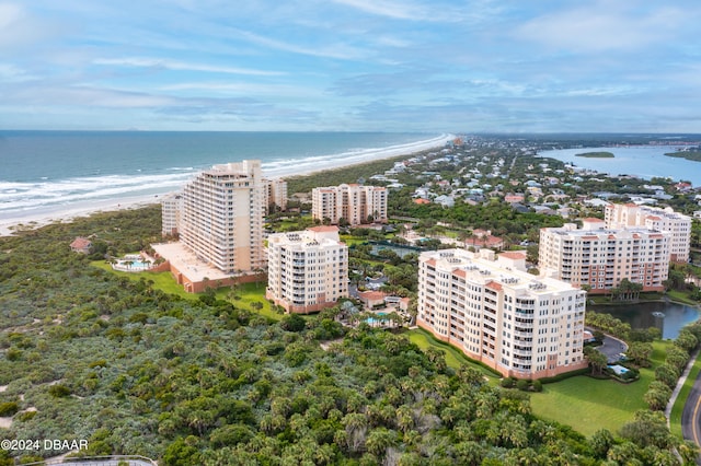 bird's eye view with a water view and a beach view