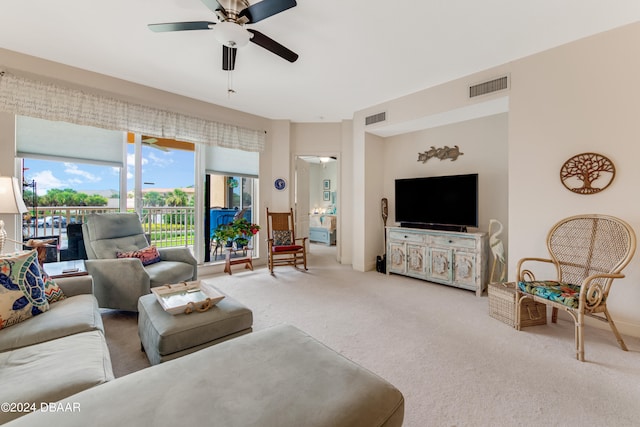 living room featuring carpet floors and ceiling fan