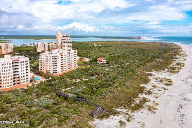 birds eye view of property with a water view and a view of the beach