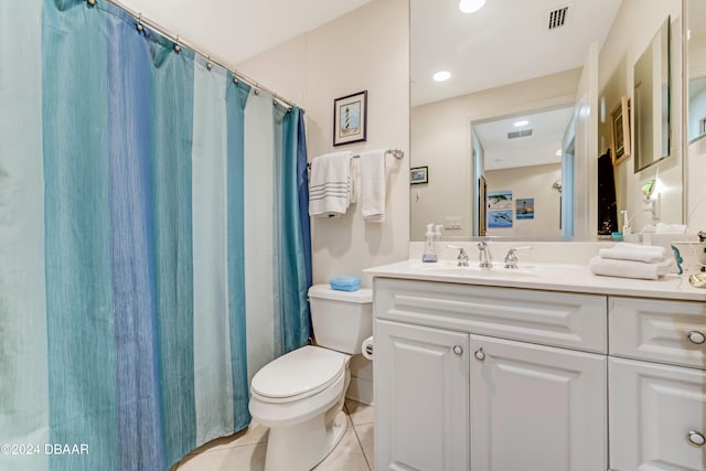 bathroom with vanity, tile patterned flooring, and toilet