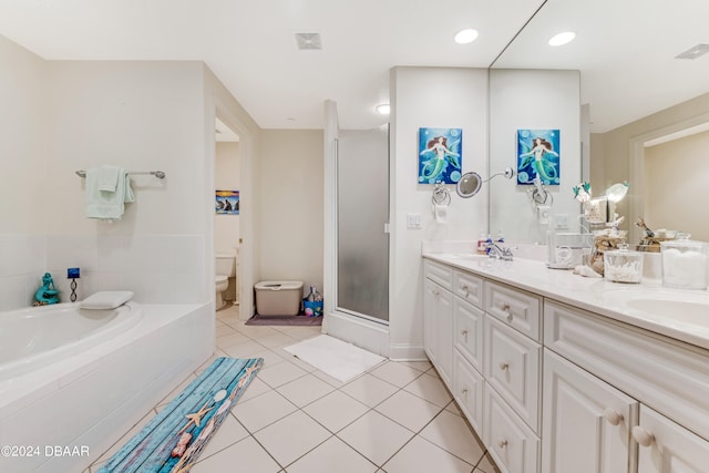 full bathroom featuring toilet, vanity, tile patterned flooring, and separate shower and tub