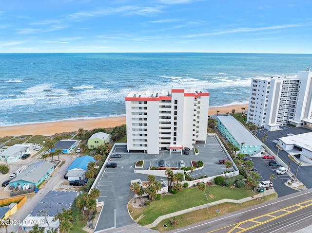 birds eye view of property with a water view and a view of the beach