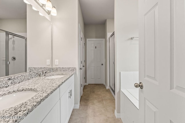 bathroom with tile patterned flooring, vanity, and a shower with shower door