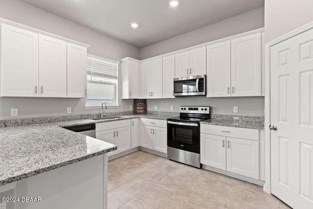 kitchen featuring light stone countertops, sink, white cabinets, and appliances with stainless steel finishes