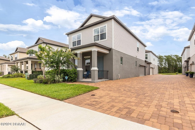 view of front of house featuring a garage and a front lawn