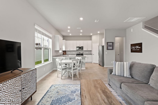 living room with light tile patterned floors and sink