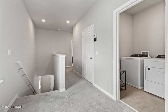 interior space featuring light carpet and washer and dryer