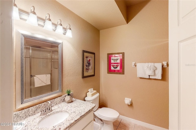 bathroom featuring vanity, tile patterned flooring, and toilet