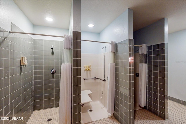 bathroom with a shower with shower curtain, a textured ceiling, and tile patterned floors