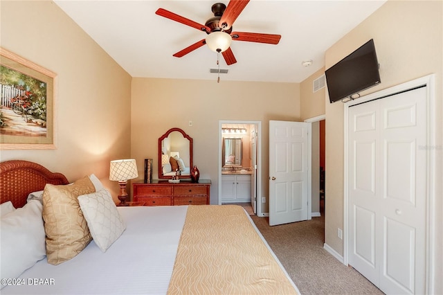 bedroom with connected bathroom, a closet, light carpet, and ceiling fan