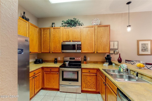 707 Gran Bahama Blvd, Davenport, FL 33897 - kitchen featuring appliances with stainless steel finishes, a sink, light countertops, and light tile patterned floors