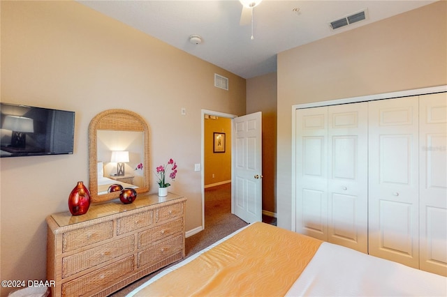 bedroom featuring ceiling fan, dark colored carpet, and a closet