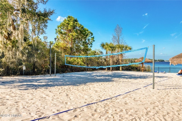 view of community with a water view and volleyball court