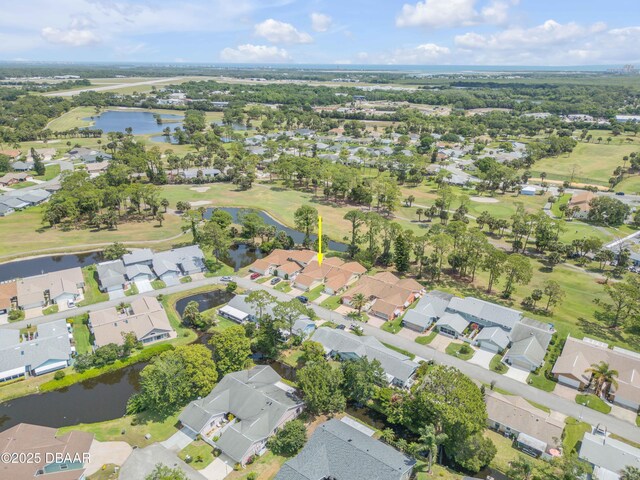 view of property location featuring nearby suburban area, a nearby body of water, and a local golf course