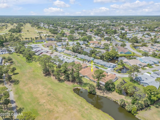 aerial view of property's location featuring a nearby body of water, nearby suburban area, and a local golf course