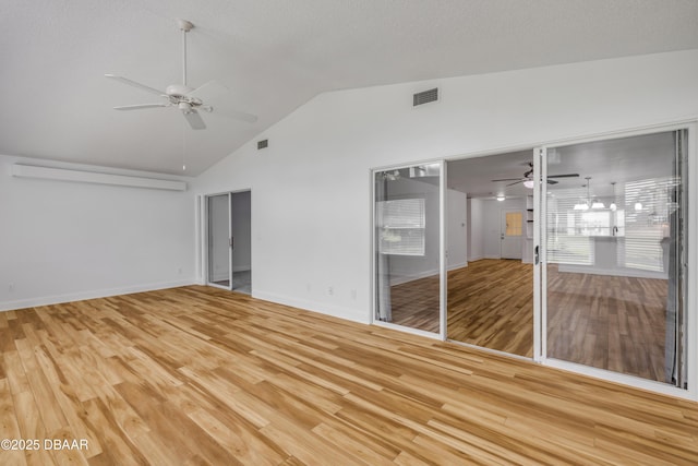unfurnished bedroom featuring vaulted ceiling, light wood-style floors, baseboards, and ceiling fan