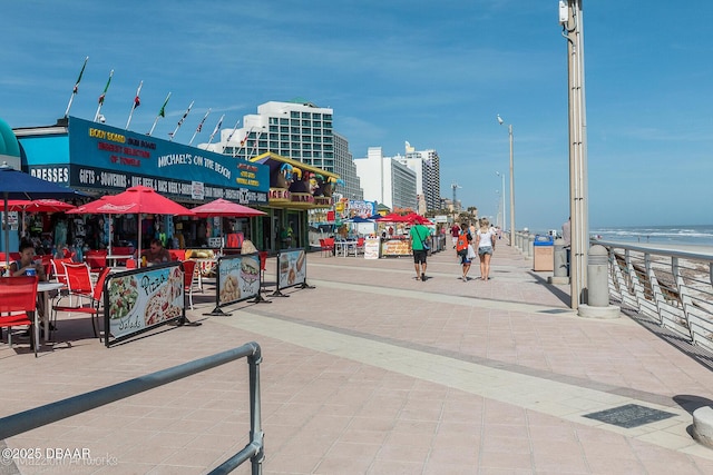 view of home's community with a beach view and a water view