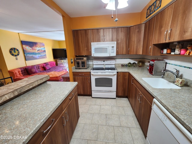 kitchen with light tile patterned floors, white appliances, and sink