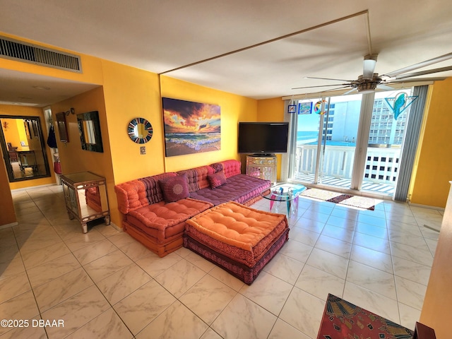 living room with ceiling fan and expansive windows