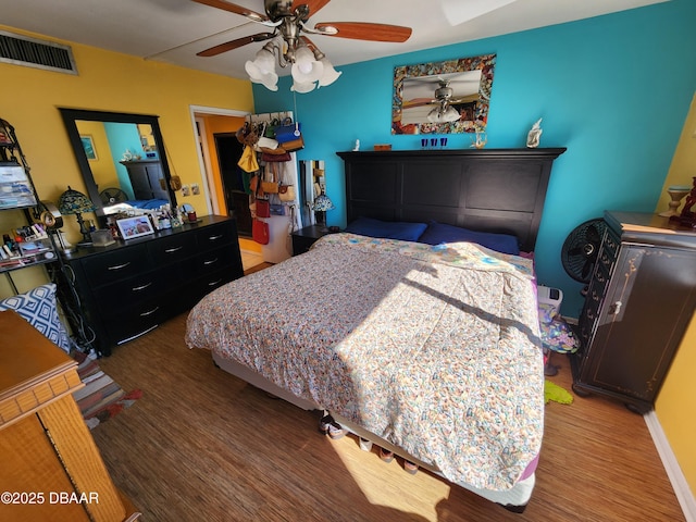 bedroom featuring hardwood / wood-style floors and ceiling fan