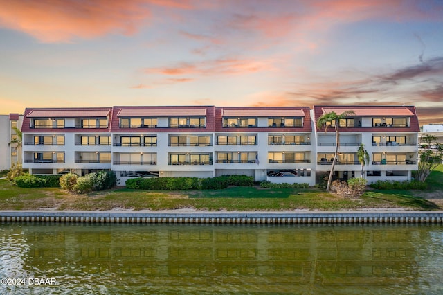 outdoor building at dusk featuring a water view