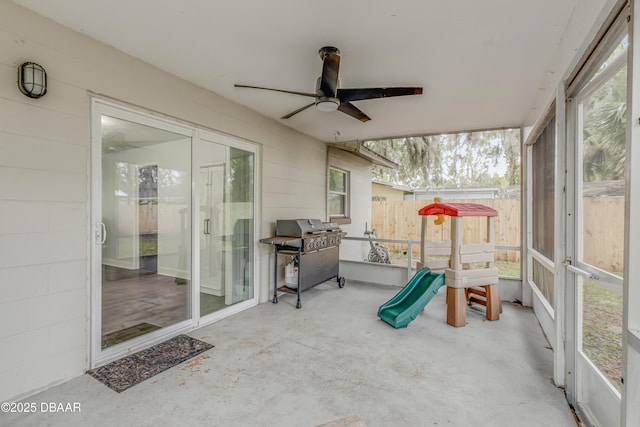 sunroom featuring a wealth of natural light and ceiling fan