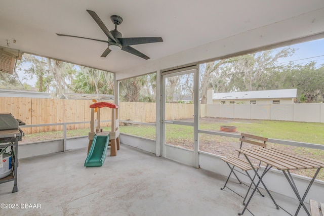 sunroom / solarium featuring a wealth of natural light and ceiling fan