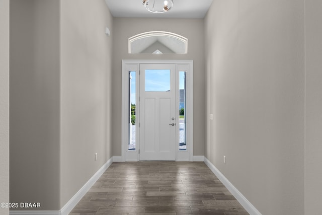 foyer featuring a notable chandelier and dark hardwood / wood-style floors