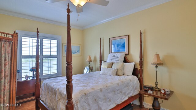 bedroom featuring ornamental molding, hardwood / wood-style flooring, and ceiling fan